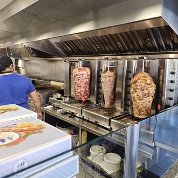 Gyro City - a man preparing food in a commercial kitchen - Greek Near Me - Boston, Massachusetts