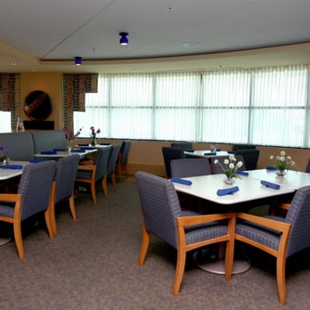 Just Off Main - a dining room with blue chairs and a white table - Breakfast & Brunch Near Me - North Myrtle Beach, South Carolina Just Off Main - a dining room with blue chairs and a white table - Breakfast & Brunch Near Me - North Myrtle Beach, South Carolina