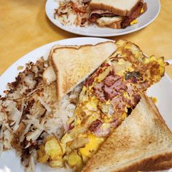 Poppy's Top Dog - Western omelet, shredded hasbrowns with onions, white toast and a meat sandwich.