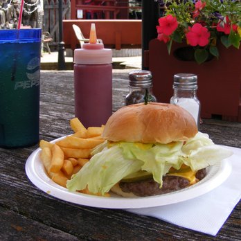 Sawmill Saloon - a hamburger and fries on a plate - Bars Near Me - Big Rapids, Michigan