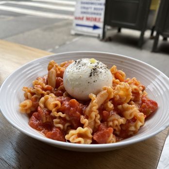 Pasta Louise Cafe - a plate of pasta and a soft boiled egg - Italian Near Me - Brooklyn, New York Pasta Louise Cafe - a plate of pasta and a soft boiled egg - Italian Near Me - Brooklyn, New York