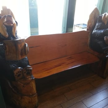 Black Bear Diner Gilroy - Typical interior décor - old style wooden bench in the waiting area, complete with wooden bear statues - Diners Near Me - Gilroy, California