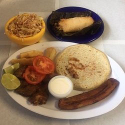 Chela's Restaurant - Our sampler with a pupusa tamale chicharron and yuca