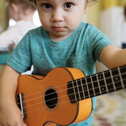 Yellow Bird Music - A child exploring the ukulele.