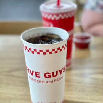 Five Guys - My drink in-line with my wife's drink in-line with her ketchup. But is it art? - Burgers Near Me - Joplin, Missouri