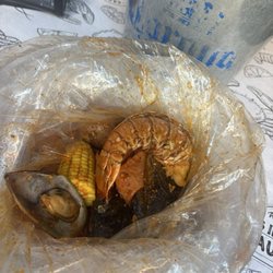 Boil with mussels, corn, potatoes, Sausages, and lobster tail