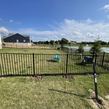 House Power - a fenced backyard with a pool in the background - General Contractors Near Me House Power - a fenced backyard with a pool in the background - General Contractors Near Me