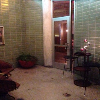 Garage - Entrance, with a window that looks in on the bartenders. - Cocktail Bars Near Me - Austin, Texas