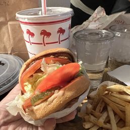 Burger animal style with extra lettuce tomatoes.
