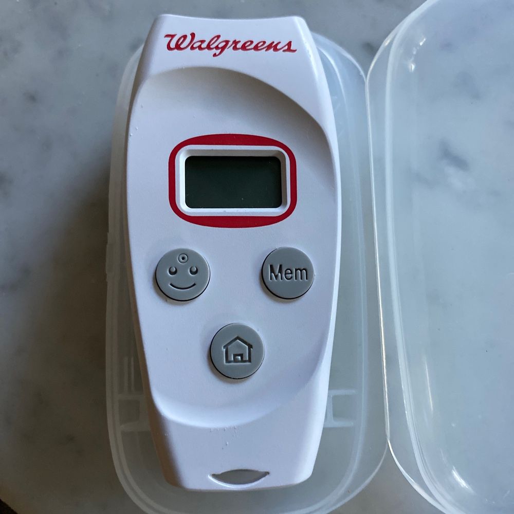 a digital thermometer in a plastic container a digital thermometer in a plastic container