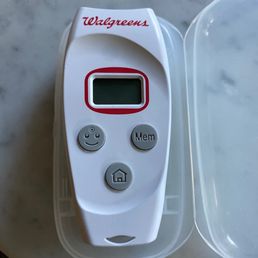 a digital thermometer in a plastic container