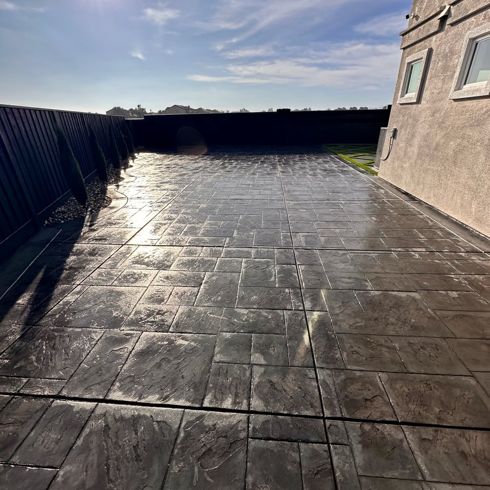 Complete Landscape - STAMPED CONCRETE WITH SEALANT, ALSO CURVED BORDER WITH CYPRESS TREES & DECORATIVE ROCKS. FENCE STAINED - Landscaping Near Me - Oakley, California Complete Landscape - STAMPED CONCRETE WITH SEALANT, ALSO CURVED BORDER WITH CYPRESS TREES & DECORATIVE ROCKS. FENCE STAINED - Landscaping Near Me - Oakley, California