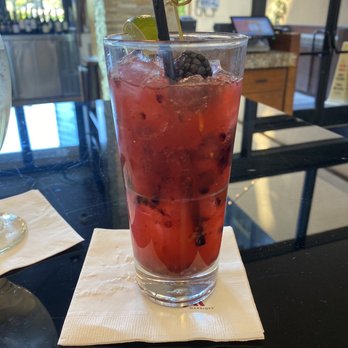 Amuse - a glass of watermelon drink on a napkin - Steakhouses Near Me - La Jolla, California