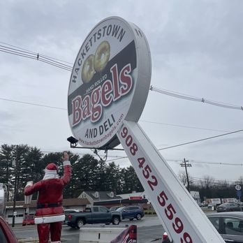 Hackettstown Bagels - a man in a santa suit fixing a bagel sign - Bagels Near Me - Hackettstown, New Jersey
