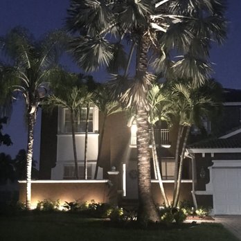 Tropical Landscape Lighting - a palm tree in front of a house - Landscaping Near Me - Lake Worth, Florida Tropical Landscape Lighting - a palm tree in front of a house - Landscaping Near Me - Lake Worth, Florida