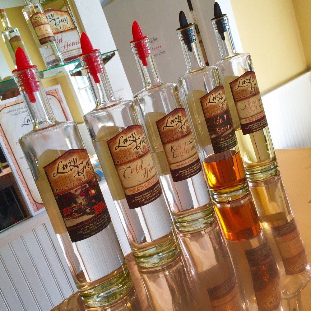 Lazy Guy Distillery - a row of bottles of liquor - Distilleries Near Me - Kennesaw, Georgia Lazy Guy Distillery - a row of bottles of liquor - Distilleries Near Me - Kennesaw, Georgia