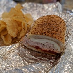 Sorrento Importing - Turkey, mozz, roasted red pepper sandwich with oil and vinegar. And Alfredo's chips.