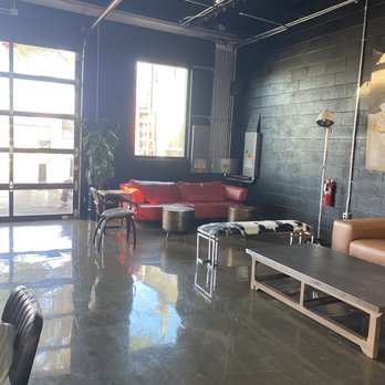 Eagle's Dare - a living area with a couch, coffee table, chairs, and a fire hydrant - Bars Near Me - Wilmington, North Carolina Eagle's Dare - a living area with a couch, coffee table, chairs, and a fire hydrant - Bars Near Me - Wilmington, North Carolina