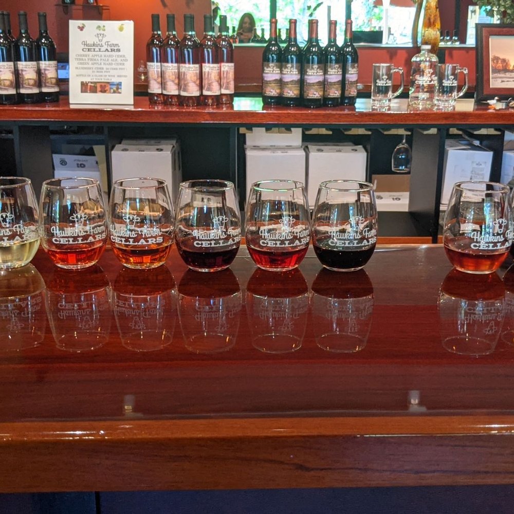Hawkins Farms Cellars - a row of wine glasses on a bar - Pizza Near Me - Suttons Bay, Michigan Hawkins Farms Cellars - a row of wine glasses on a bar - Pizza Near Me - Suttons Bay, Michigan