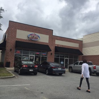 Larry's Giant Subs - a woman walking in front of the store - Delis Near Me - Brunswick, Georgia