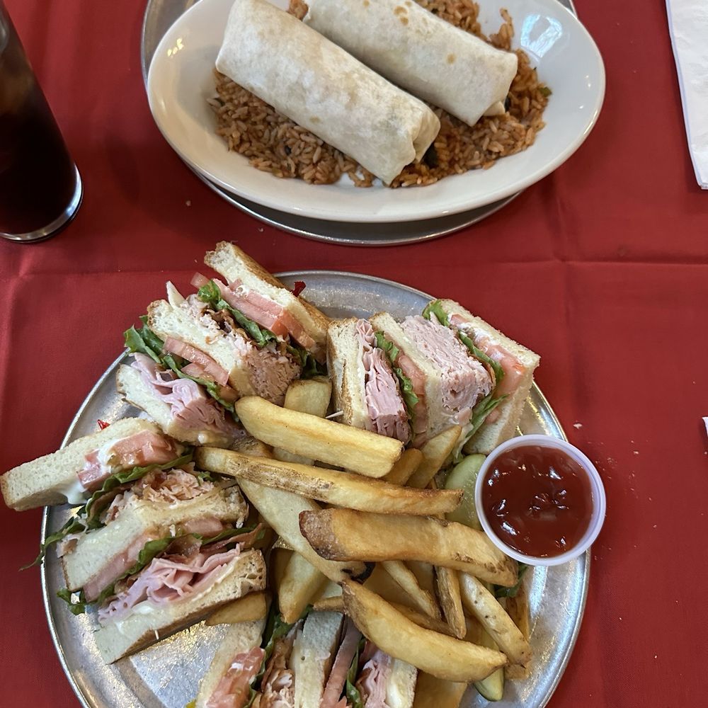 Club sandwich with turkey and ham, steak fries, burrito with salsa and jalepenos over a bed of Spanish rice. Club sandwich with turkey and ham, steak fries, burrito with salsa and jalepenos over a bed of Spanish rice.