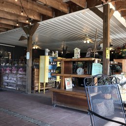 A store inside and outdoor seats A store inside and outdoor seats