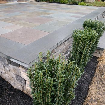 Lasting Impression Landscaping - a patio with a stone wall - Landscaping Near Me - Wenonah, New Jersey Lasting Impression Landscaping - a patio with a stone wall - Landscaping Near Me - Wenonah, New Jersey