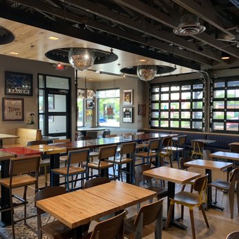 Raising Cane's Chicken Fingers - tables and chairs in a restaurant - Chicken Shop Near Me - Cincinnati, Ohio Raising Cane's Chicken Fingers - tables and chairs in a restaurant - Chicken Shop Near Me - Cincinnati, Ohio