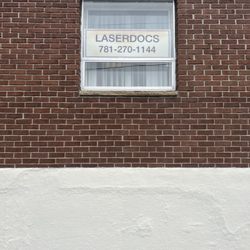 Cosmetic Laser Clinic - Sign in the side window of Laser Docs  Cosmetic Laser Clinic. The entrance...  is around the corner!
