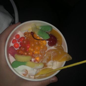 Yogurtland - A Yogurtland cup containing coconut frozen yogurt, peach slices, a cherry, gummy worms, and popping boba. - Ice Cream & Frozen Yogurt Near Me - Tustin, California Yogurtland - A Yogurtland cup containing coconut frozen yogurt, peach slices, a cherry, gummy worms, and popping boba. - Ice Cream & Frozen Yogurt Near Me - Tustin, California