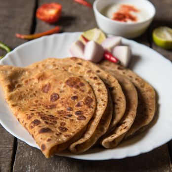 Divine Dhaaba - a plate of flatbreads on a wooden table - Indian Near Me - Redlands, California Divine Dhaaba - a plate of flatbreads on a wooden table - Indian Near Me - Redlands, California