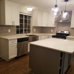 GPE Home Design - Completed a chic kitchen upgrade with crisp white cabinets, a gray island, and beautiful white quartz countertops for a timeless look!