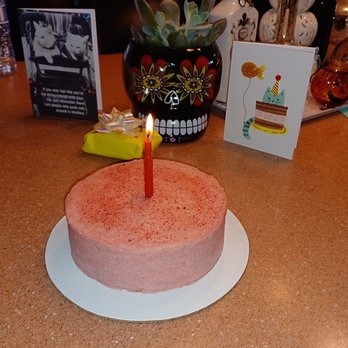 Petite Paleo Bakery - a pink cake with a single lit candle - Custom Cakes Near Me Petite Paleo Bakery - a pink cake with a single lit candle - Custom Cakes Near Me