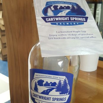 Cartwright Springs - a bottle of bottled water on a table - Breweries Near Me - Pakenham, Ontario