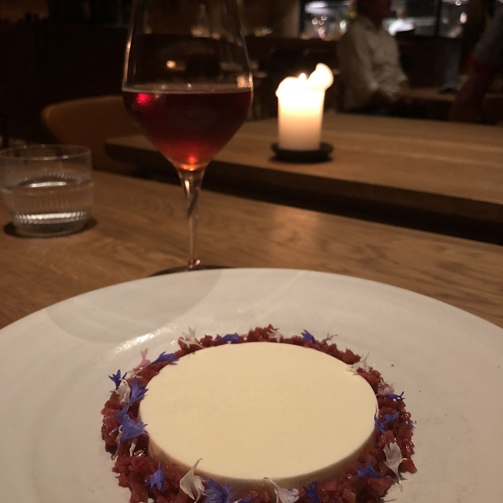 Barr - Crème fraîche custard with rhubarb sorbet buried below. Beautiful blossoms all around. This wine pairing was superb. - Modern European Near Me - København