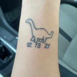 Dinosaur tattoo with date Dinosaur tattoo with date