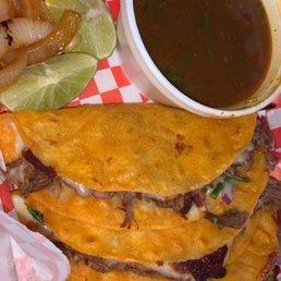 Quesabirria tacos with a side of consomé.