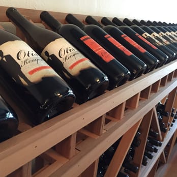 Otis Kenyon Wine - rows of wine bottles on a wooden shelf - Wineries Near Me - Walla Walla, Washington Otis Kenyon Wine - rows of wine bottles on a wooden shelf - Wineries Near Me - Walla Walla, Washington