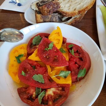 Olive + Oak - Heirloom tomatoes, olive oil, basil and salt. A simple appetizer inspired by the Chef's trip to Italy. - Wine Bars Near Me - Saint Louis, Missouri Olive + Oak - Heirloom tomatoes, olive oil, basil and salt. A simple appetizer inspired by the Chef's trip to Italy. - Wine Bars Near Me - Saint Louis, Missouri