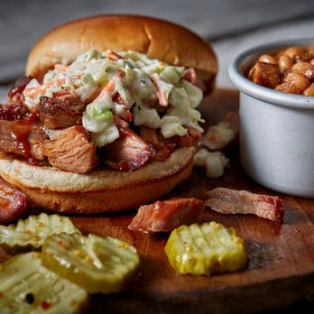 Famous Dave's Bar-B-Que - ows a pulled pork sandwich with coleslaw and pickles - Barbeque Near Me - Orland Park, Illinois Famous Dave's Bar-B-Que - ows a pulled pork sandwich with coleslaw and pickles - Barbeque Near Me - Orland Park, Illinois