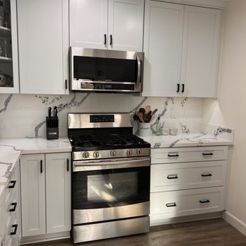 Construction Concern - a kitchen with white cabinets and stainless steel appliances - General Contractors Near Me - Newhall, California