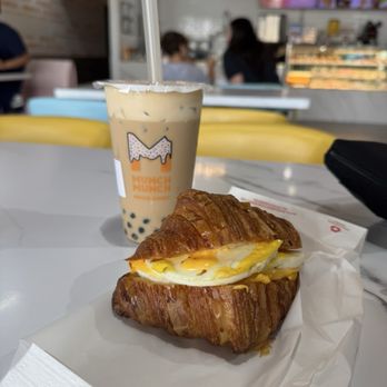 Munch Munch Mochi Donut - Egg and cheese croissant breakfast sandwich, with iced milk tea latte with added tapioca pearls - Donuts Near Me - Shenandoah, Texas