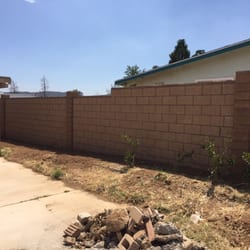 Uribe and Son’s Concrete and Masonry - Tan split face block with mission slumpstone columns and cap