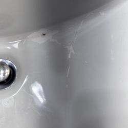 WoodSpring Suites Seattle Tukwila - BIG crack in the sink that someone made a poor attempt to repair