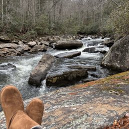 Stopping for a little hiking break on a large rock in the river. Stopping for a little hiking break on a large rock in the river.