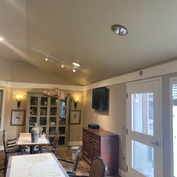 Comfort Restoration - a dining room with a flat screen tv - General Contractors Near Me