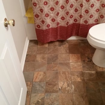 Mallett Tile - a bathroom with a toilet and shower curtain - Flooring Near Me Mallett Tile - a bathroom with a toilet and shower curtain - Flooring Near Me