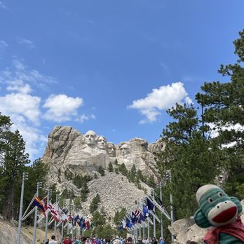 Mount Rushmore National Memorial - Harold the sock monkey enjoying the view of the Avenue of flags - Landmarks & Historical Buildings Near Me - Keystone, South Dakota