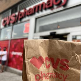 a brown paper bag with the cvs pharmacy logo on it a brown paper bag with the cvs pharmacy logo on it
