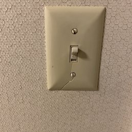 Broken light switch panel. Broken light switch panel.
